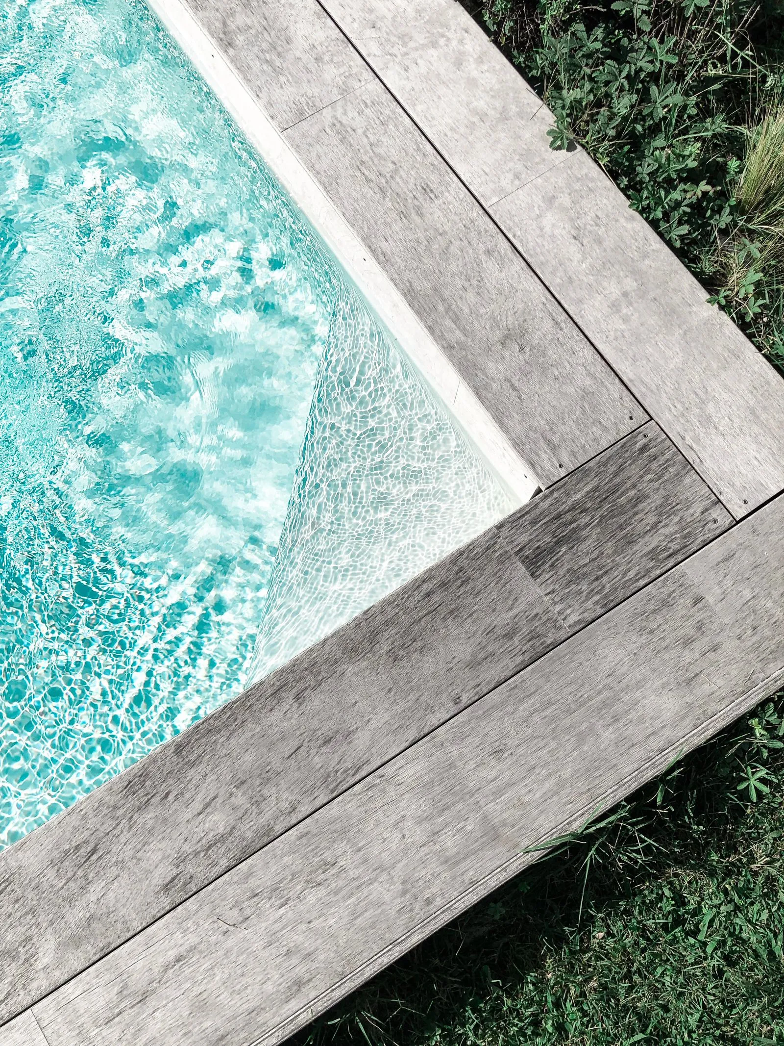A clean residential pool with timber decking